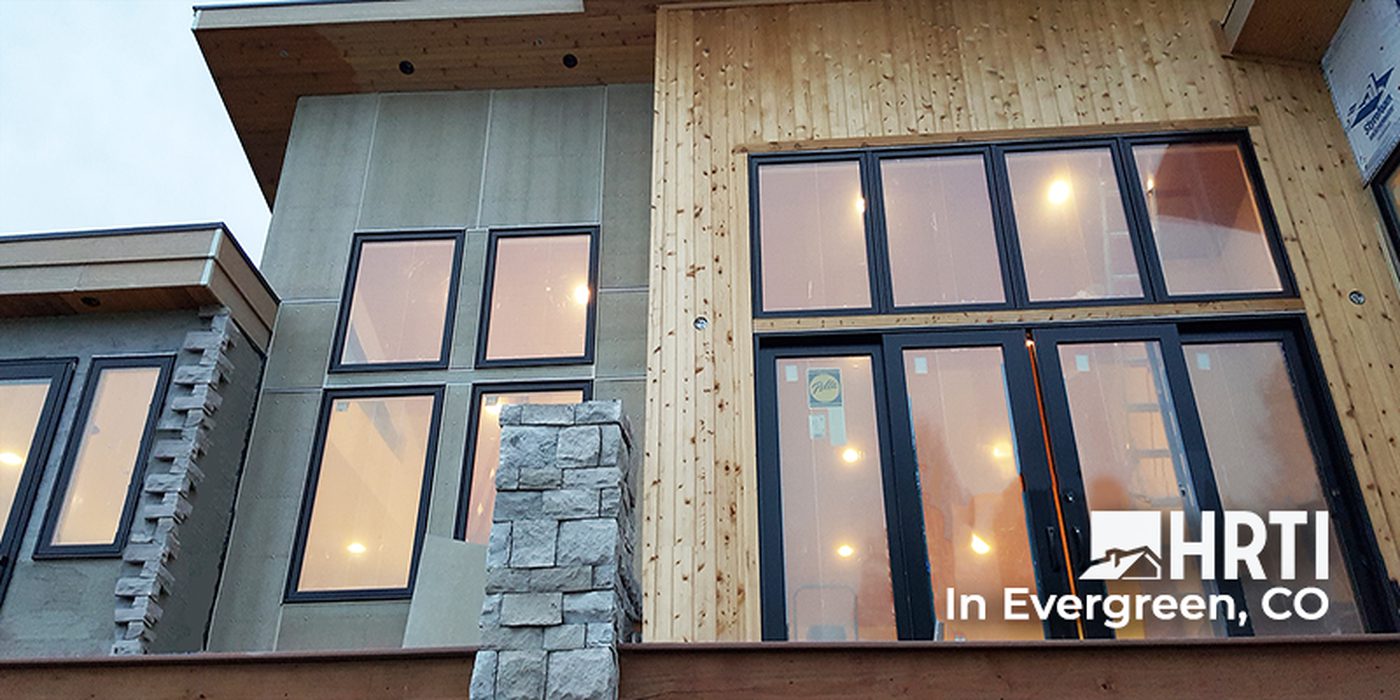 Knotty pine siding accents and new Pella windows on this Evergreen home