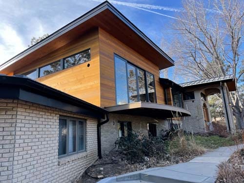 The clear coat cedar siding on this Boulder home accents the stonework beautifully